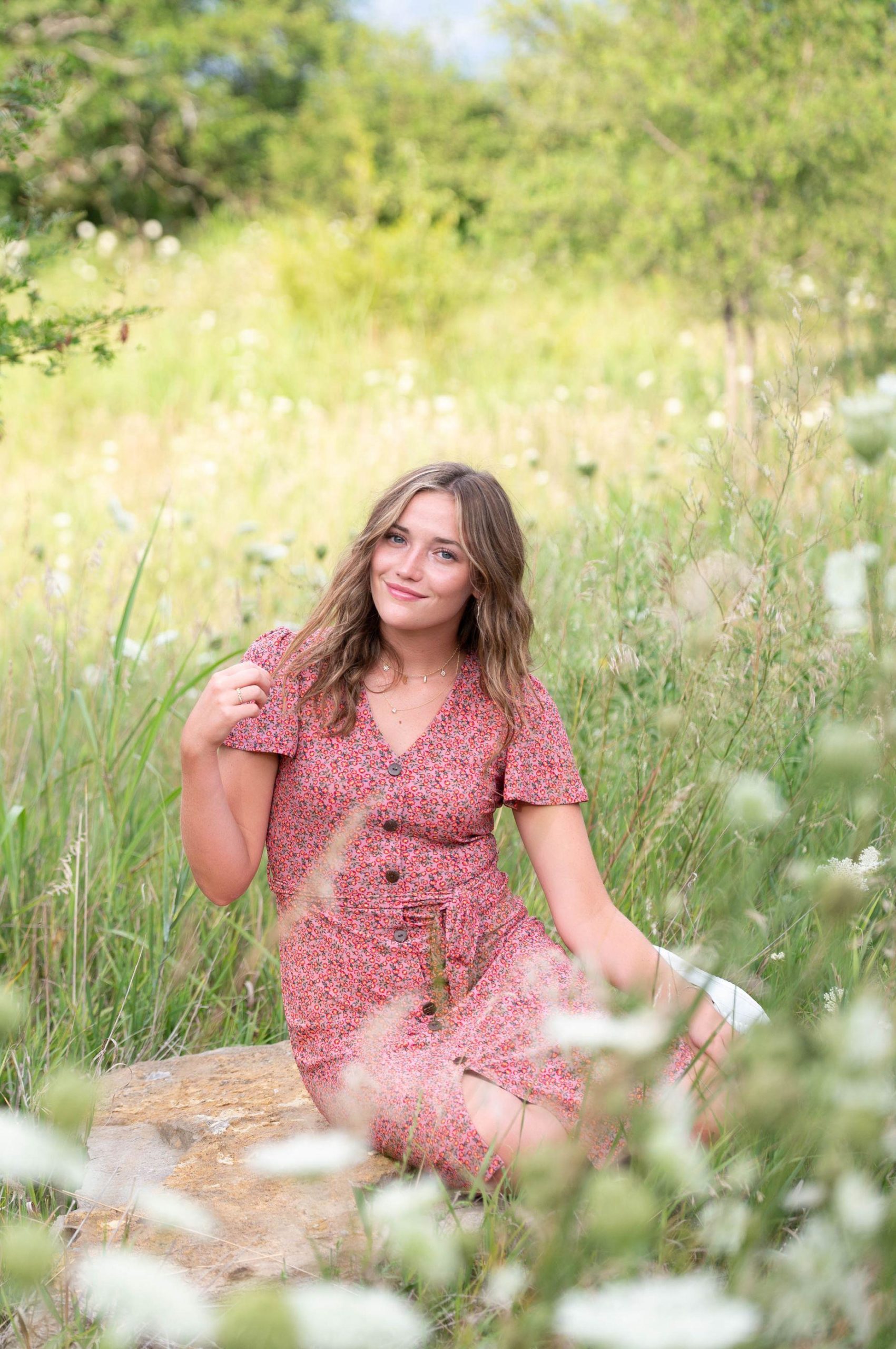 Best Time to Book My Senior Photo: Senior Girl in grass and wild flowers in the spring