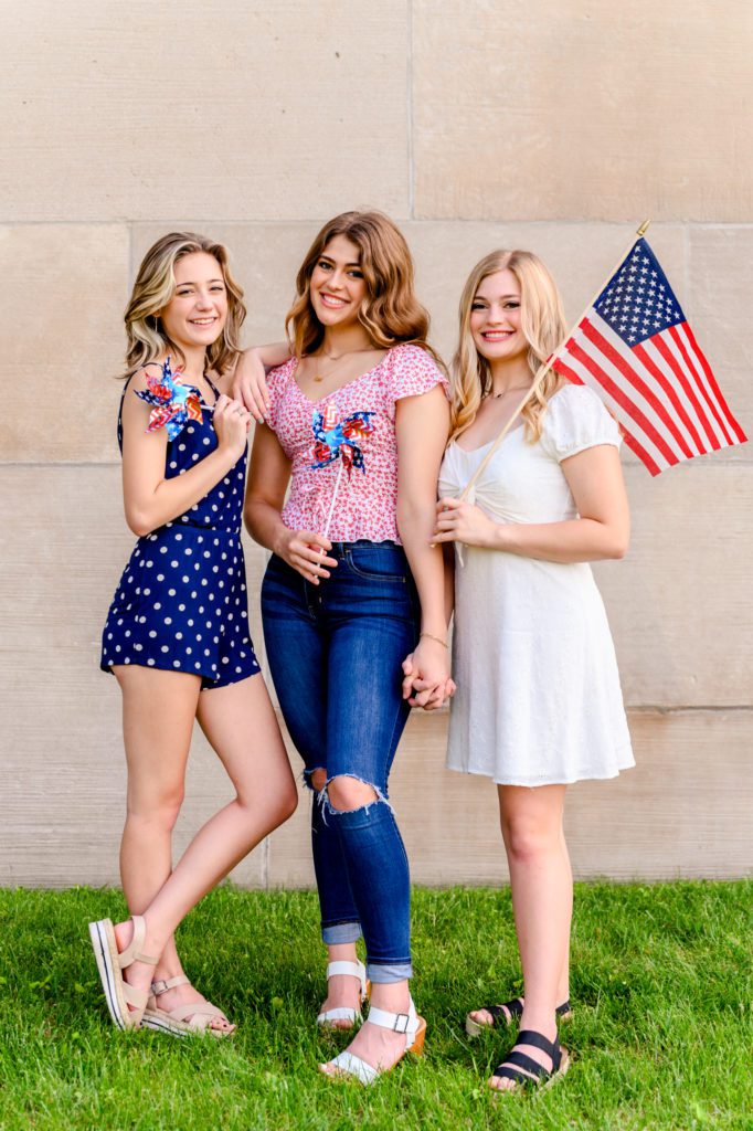 4th of July Model Team photoshoot. 3 girls holding flags 